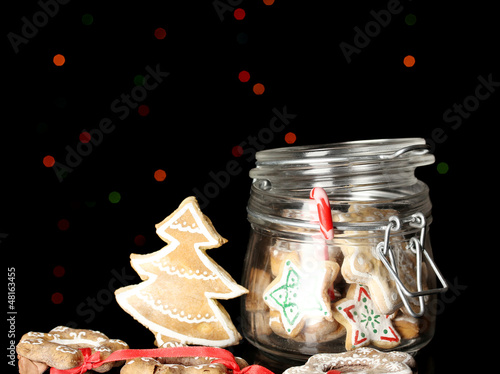 Photo: Christmas treats in bank on Christmas lights background Christmas treats in bank on Christmas lights background