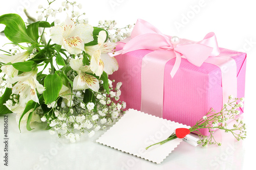 Photo: Giftbox and flowers isolated on white Giftbox and flowers isolated on white