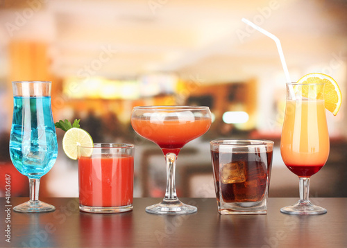 Photo: Several glasses of different drinks on bright background Several glasses of different drinks on bright background