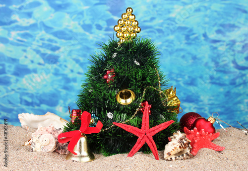 Photo: Christmas tree on sand in beach Christmas tree on sand in beach