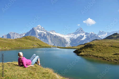 Photo: Traveler in the Alpine meadow. Jungfrau region, Switzerland Traveler in the Alpine meadow. Jungfrau region, Switzerland