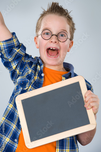 Photo: happy boy with little blackboard happy boy with little blackboard