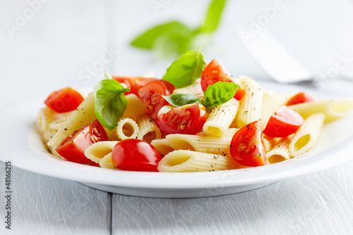 Photo: Pasta salad with cherry tomatoes and basil leaves Pasta salad with cherry tomatoes and basil leaves