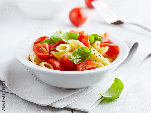 Photo: Pasta salad with cherry tomatoes and basil leaves Pasta salad with cherry tomatoes and basil leaves