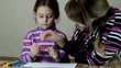 mother and daughter paint pens on white paper