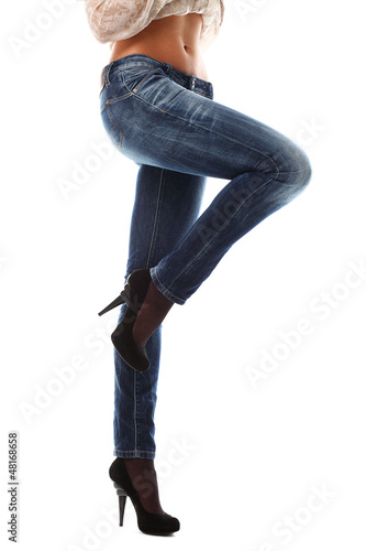 Photo: Closeup of beautiful legs in jeans Closeup of beautiful legs in jeans