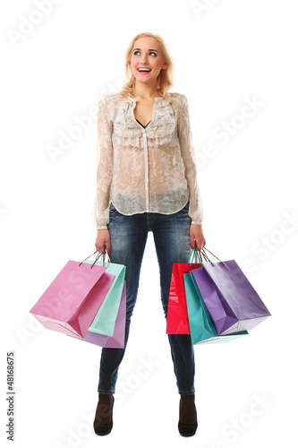 Photo: Young woman holds shopping bags and smiling Young woman holds shopping bags and smiling