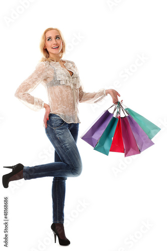 Photo: Young beautiful woman holds bags and smiling Young beautiful woman holds bags and smiling