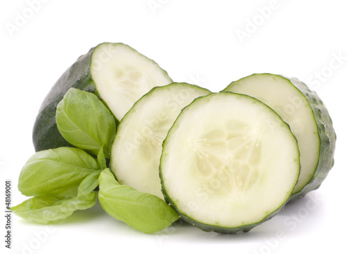 Photo: Sliced cucumber vegetable and basil leaves still life Sliced cucumber vegetable and basil leaves still life