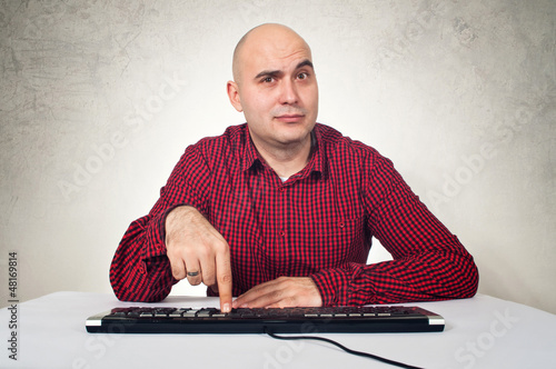 Photo: man with computer keybaord man with computer keybaord