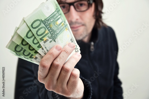 Photo: Man paying in euros Man paying in euros
