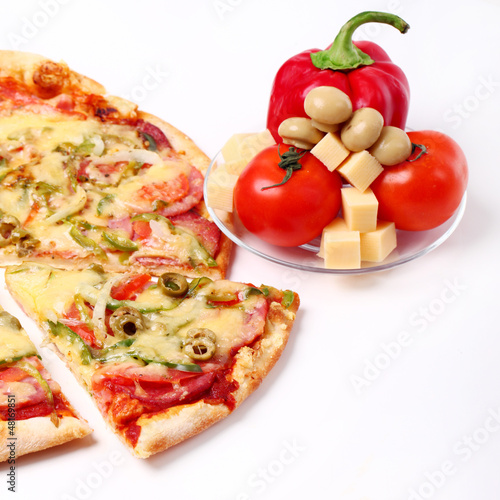 Photo: Image of sliced pizza and vegetables isolated Image of sliced pizza and vegetables isolated