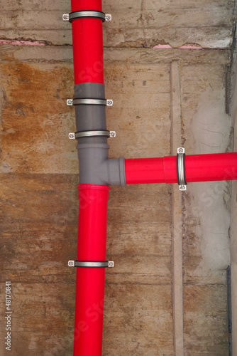 Photo: Red plastic water pipes Red plastic water pipes