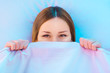 Shy girl in bed smiling