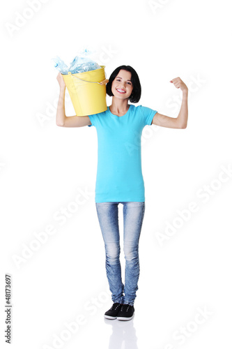 Photo: Beautiful young woman holding recycling bin Beautiful young woman holding recycling bin