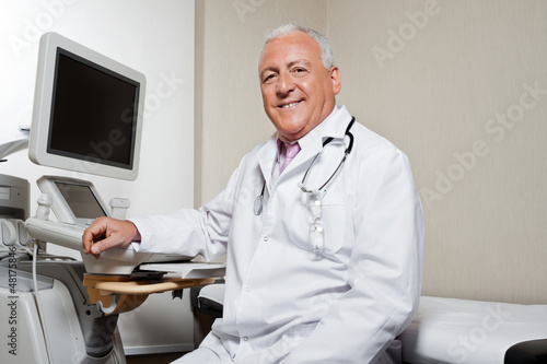 Photo: Radiologist Sitting By Ultrasonic Machine Radiologist Sitting By Ultrasonic Machine