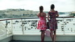 Two women stopping on the bridge in the city, steadycam shot