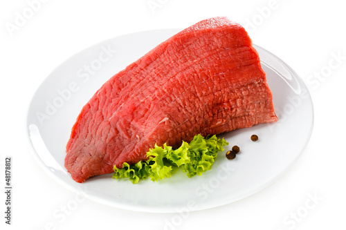 Photo: Raw beef and vegetables on white background Raw beef and vegetables on white background
