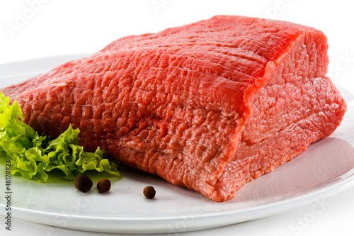 Photo: Raw beef and vegetables on white background Raw beef and vegetables on white background