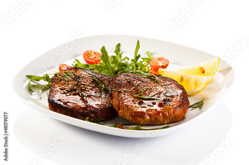 Photo: Grilled steaks and vegetables Grilled steaks and vegetables
