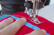 Hands of tailor sewing clothes
