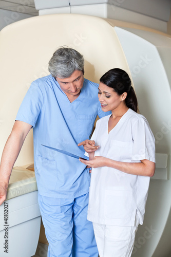 Photo: Technicians Standing by MRI Machine Technicians Standing by MRI Machine