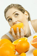 portrait of young woman eating orange