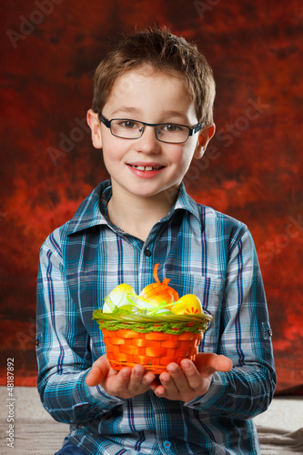 Photo: boyl with a basket full of easter eggs boyl with a basket full of easter eggs