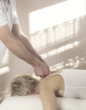 Male therapist treating female, soft focus