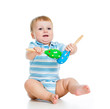 Baby  boy playing with musical toys. Isolated on white backgroun