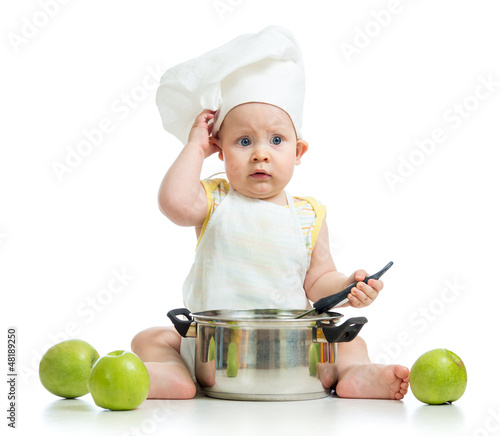 Photo: funny adorable baby with green apples isolated on white backgrou funny adorable baby with green apples isolated on white backgrou