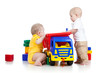 two little children playing with color toys
