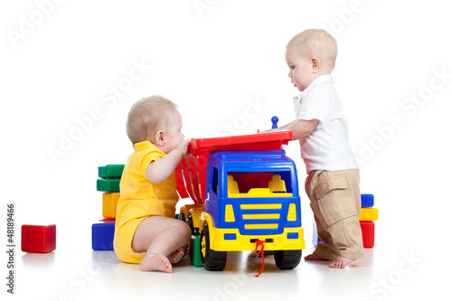 Photo: two little children playing with color toys two little children playing with color toys