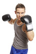 Muscular young man boxing in sports outfit