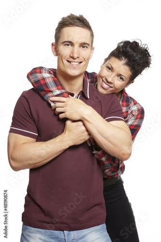 Photo: Young couple cuddling and smiling Young couple cuddling and smiling