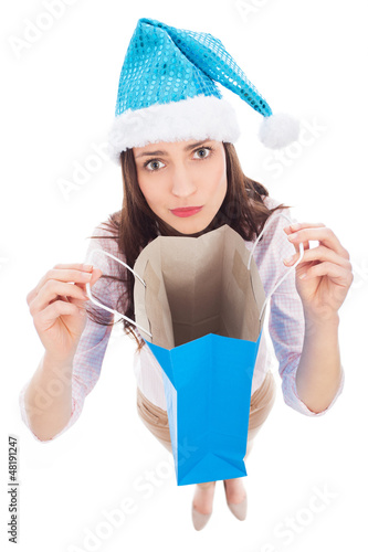 Photo: Woman in Santa hat holding empty bag Woman in Santa hat holding empty bag