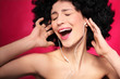 Woman with afro hair enjoying music