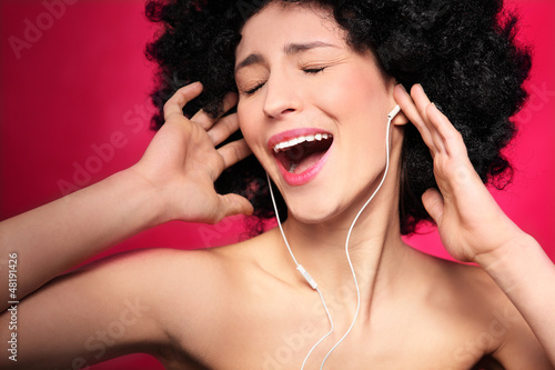 Photo: Woman with afro hair enjoying music Woman with afro hair enjoying music