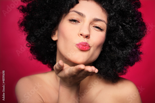 Photo: Woman with afro blowing a kiss Woman with afro blowing a kiss