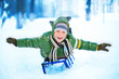 Little boy on sleigh