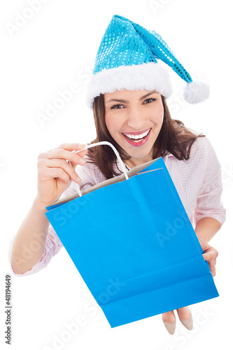 Photo: Woman in Santa hat holding shopping bag Woman in Santa hat holding shopping bag