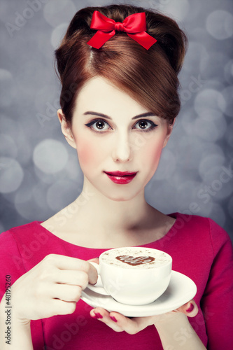 Photo: Redhead girl with coffee cup. St. Valentine Day. Redhead girl with coffee cup. St. Valentine Day.
