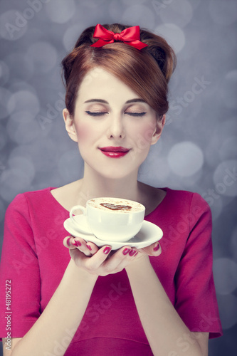 Photo: Redhead girl with coffee cup. St. Valentine Day. Redhead girl with coffee cup. St. Valentine Day.