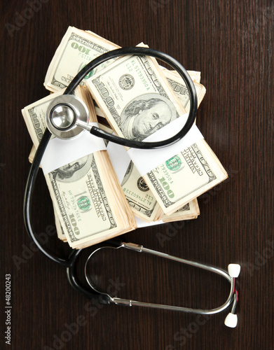 Photo: Healthcare cost concept: stethoscope and dollars Healthcare cost concept: stethoscope and dollars