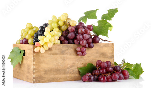 Photo: assortment of ripe sweet grapes in wooden crate, isolated assortment of ripe sweet grapes in wooden crate, isolated