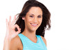 pretty young woman giving ok hand sign over white background