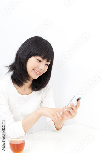 Photo: attractive asian woman using smart phone attractive asian woman using smart phone