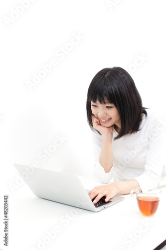 Photo: attractive asian woman using laptop attractive asian woman using laptop