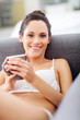attractive young woman in underwear relaxing at home with coffee