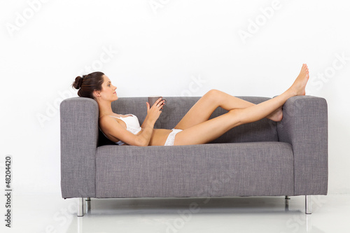 Photo: sexy young woman in underwear relaxing on sofa with coffee sexy young woman in underwear relaxing on sofa with coffee